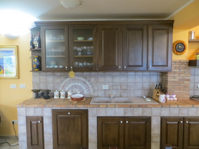  cucina realizzata completamente in legno rivestita di piastrelle, con finitura in rovere massello mordenzato 
